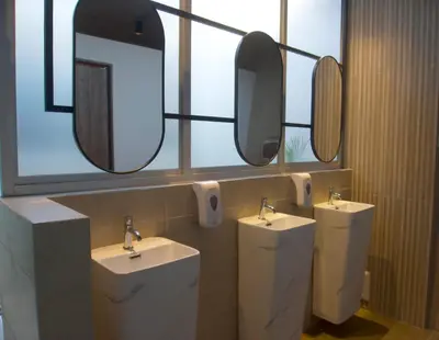 a bathroom with two sinks and two mirrors at Senoma Hotel - Adults only in Ica
