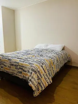a bed with a quilt on it in a room at Emilia House in Lima
