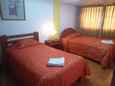 a hotel room with two beds with towels on them at Hostal Cusco Inn in Cusco