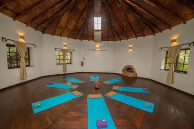 a yoga class in a room with blue mats at Andean Wings Valley in Urubamba