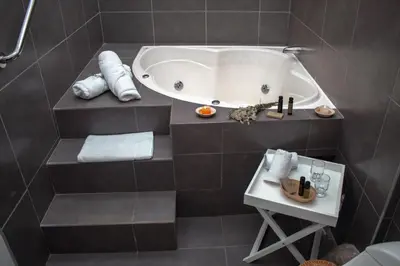 a bathroom with a bath tub and a table at Andean Wings Valley in Urubamba