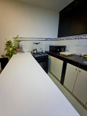 a kitchen with a white counter top in a room at Departamento completo en el primer piso in Ayacucho