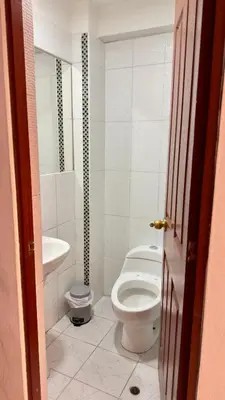 a bathroom with a toilet and a sink at Departamento completo en el primer piso in Ayacucho