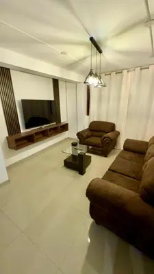 a living room with two couches and a flat screen tv at Departamento completo en el primer piso in Ayacucho