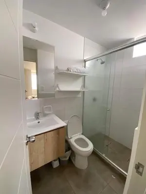a bathroom with a toilet and a sink and a shower at Departamento Costanera frente al mar in Lima