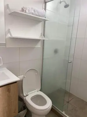a bathroom with a toilet and a glass shower at Departamento Costanera frente al mar in Lima
