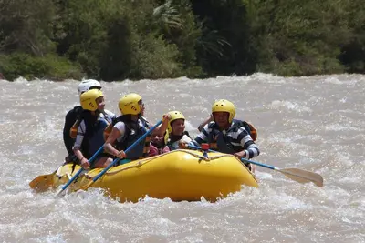 a group of people in a raft on a river at Casa Langla Lunahuana in Lunahuaná