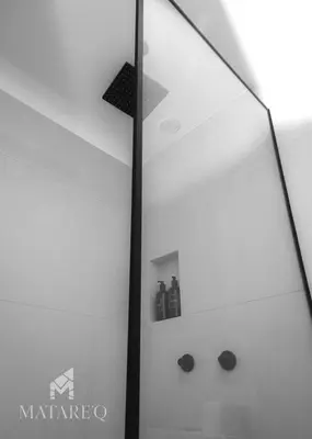 a shower in a bathroom with a glass wall at Luxury apartment steps from Plaza de Armas in Cusco