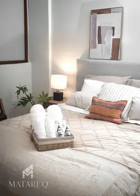 a bedroom with a bed with towels on it at Luxury apartment steps from Plaza de Armas in Cusco
