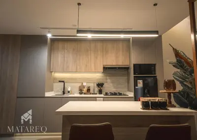 a kitchen with wooden cabinets and a white counter top at Luxury apartment steps from Plaza de Armas in Cusco