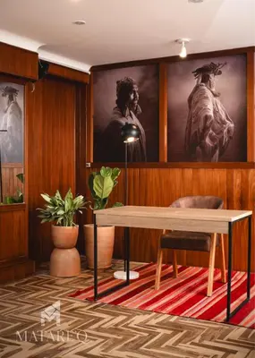 a dining room with a table and a painting at Luxury apartment steps from Plaza de Armas in Cusco