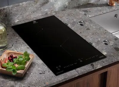 a laptop on a counter with a bowl of vegetables at Wake Up Near The Sea in Lima
