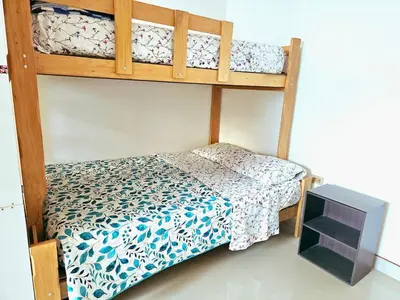 a bedroom with two bunk beds and a television at Familiar 1er piso in La Merced