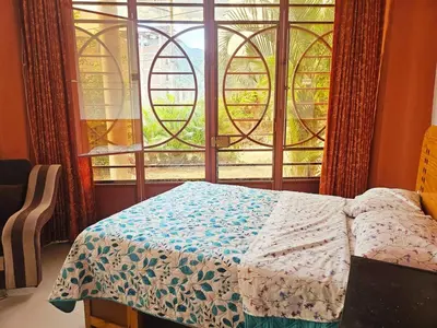 a bedroom with a bed and a large window at Familiar 1er piso in La Merced