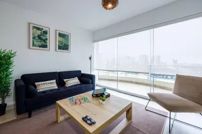 a living room with a couch and a coffee table at BSR Flat los Andes near Airport in Lima