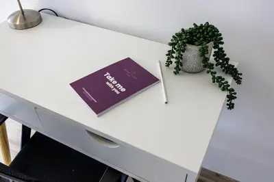 a white desk with a book and a plant on it at BSR Flat los Andes near Airport in Lima