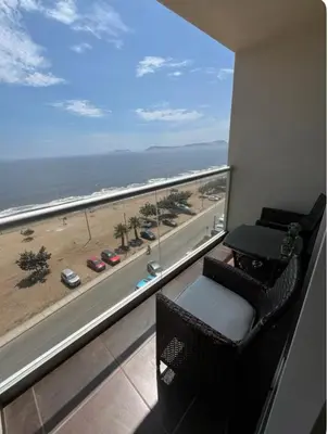 a room with a balcony with a view of the beach at Departamento con balcon y vista al mar in Lima
