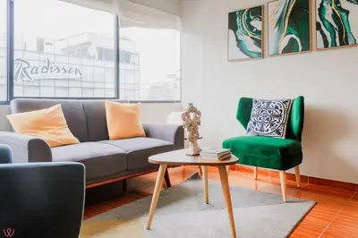 a living room with a couch and a chair at Appealing 1BR Beautiful View in Miraflores in Lima