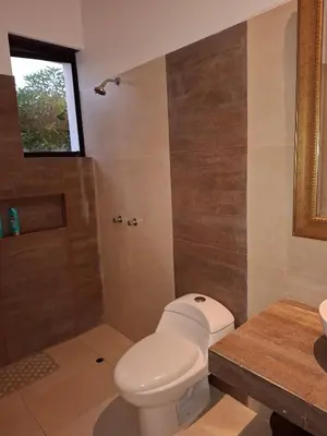 a bathroom with a toilet and a shower at Condominio ecológico las gardenias de Asia