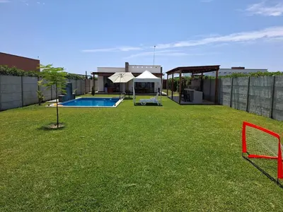 a yard with a pool and a house at Condominio ecológico las gardenias de Asia