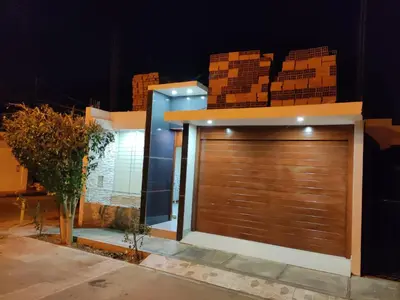 a garage door in front of a house at night at Casa Oasis Meneses in Ica