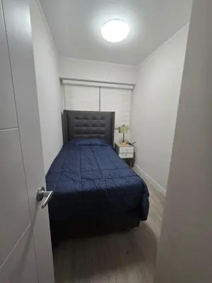 a bedroom with a bed with a blue comforter at Moderno y Exclusivo Apartamento situado en Barranco in Lima