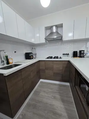 a kitchen with white cabinets and a sink and a counter at Moderno y Exclusivo Apartamento situado en Barranco in Lima