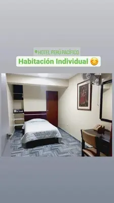 a hotel room with a bed and a desk at Hotel Perú Pacífico in Lima