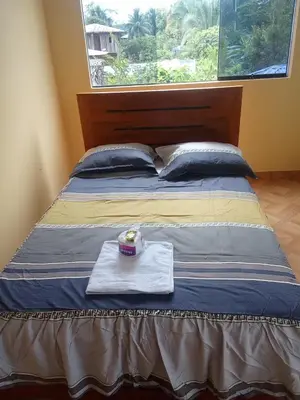 a bed with a tray with a candle on it at Hotel Kashiri in Sabeti