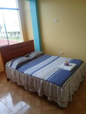 a bed in a room with a large window at Hotel Kashiri in Sabeti