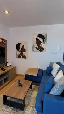 a living room with a blue couch and a coffee table at La Casita De Colores Cusco in Cusco