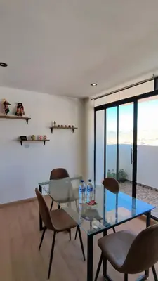 a dining room with a glass table and chairs at La Casita De Colores Cusco in Cusco