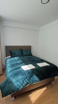 a bed with a blue comforter in a bedroom at La Casita De Colores Cusco in Cusco