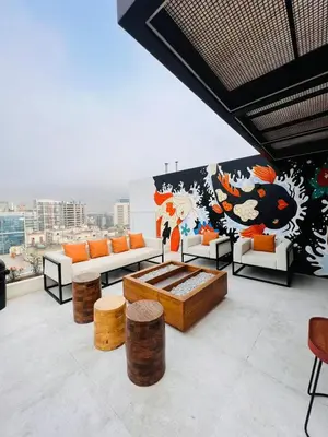 a living room with couches and a mural on a wall at Monterrico Polo Aparts 19 - Dpto de Estreno con Balcon frente Embajada USA in Lima