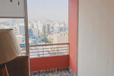 a balcony with a view of a city at Apartamento cómodo con piscina en el Centro Histórico, Lima in Lima
