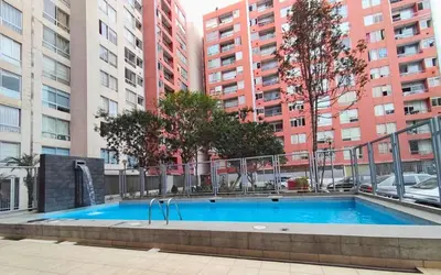a swimming pool in a city with tall buildings at Apartamento cómodo con piscina en el Centro Histórico, Lima in Lima