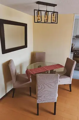 a dining room with a table and two chairs at Apartamento cómodo con piscina en el Centro Histórico, Lima in Lima