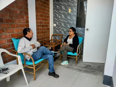 a man and a woman sitting in chairs at CASA HOSPEDAJE Conquistadores Inn