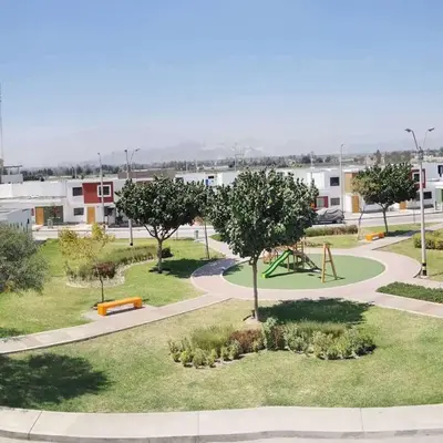 a park with a playground and a swing at CASA HOSPEDAJE Conquistadores Inn