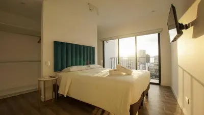 a bedroom with a bed and a large window at e-t*| Apartamento vista espectacular in Lima
