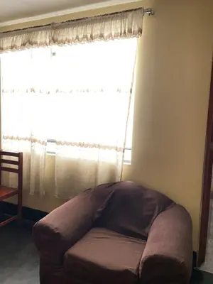 a large window with a couch in front of it at Habitación a 15 min del Aeropuerto in Lima