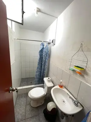 a small bathroom with a toilet and a sink at Habitación a 15 min del Aeropuerto in Lima