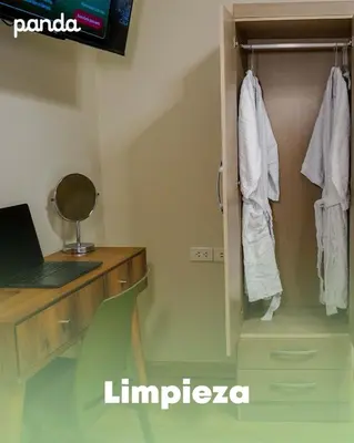 a room with a closet with a laptop and a desk at PANDA Hotel in Chancay