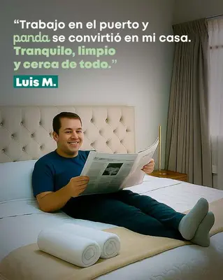 a man sitting on a bed reading a magazine at PANDA Hotel in Chancay