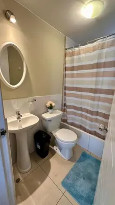 a bathroom with a toilet and a sink and a mirror at Hermoso Departamento Frente al Escuela de Oficiales de La policia in Lima