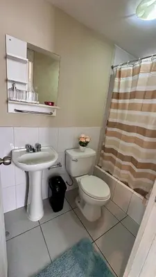 a bathroom with a toilet and a sink at Hermoso Departamento Frente al Escuela de Oficiales de La policia in Lima