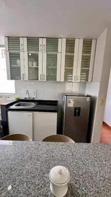 a kitchen with a counter top and a refrigerator at Hermoso Departamento Frente al Escuela de Oficiales de La policia in Lima