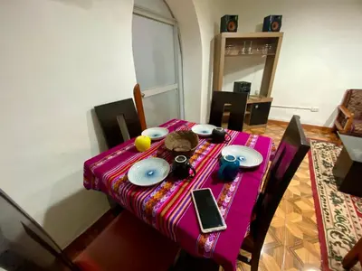 a table with a pink table cloth on it at Guadita House in Cusco