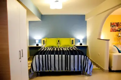 a bedroom with a bed with two yellow pillows at Historical Center Apartments in Cusco