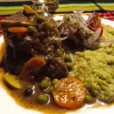 a plate of food with meat and beans and vegetables at Chunchu Wasi All included
